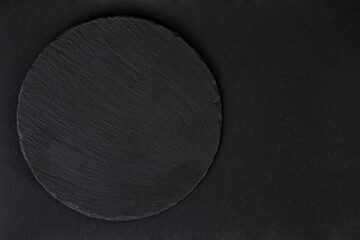 Black stone tile on black paper,