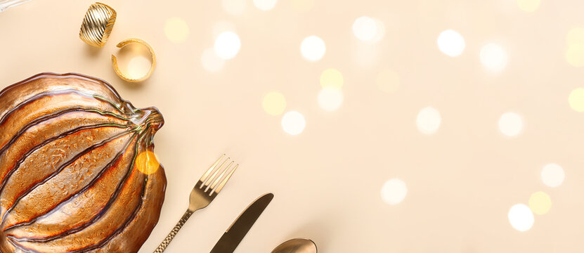 Beautiful autumn table setting on beige background with space for text