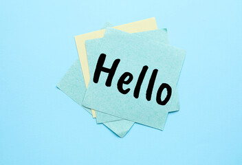 Sticky note with word HELLO on light blue background