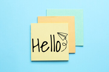 Sticky notes with word HELLO on light blue background