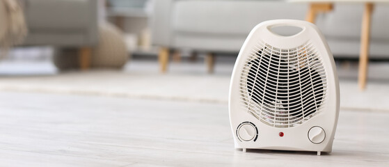 Electric fan heater on floor in living room