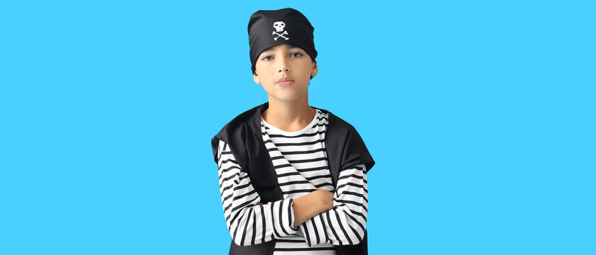 Little boy dressed as pirate on blue background