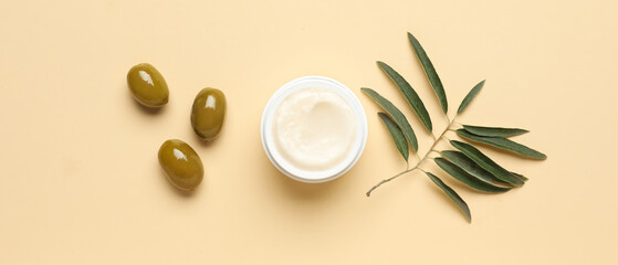 Jar of cream with olive oil extract on beige background, top view