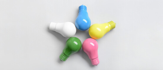 Different light bulbs on white background, top view