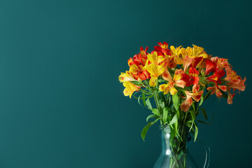 Obraz premium Jug with bouquet of beautiful alstroemeria flowers near green wall