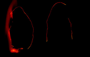 burning paper, glowing edge of paper on a black background