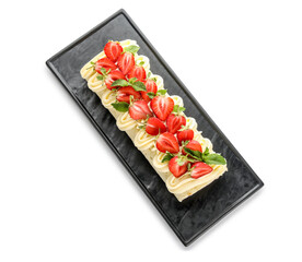 Board with tasty strawberry roll cake isolated on white background