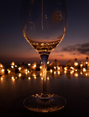 Wine glass at dusk with fence lights