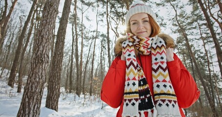 Cheerful traveling woman in winter forest