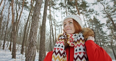 Smiling woman spending time in winter woods