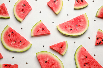 Slices of watermelon and seeds on white background