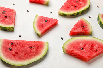 Slices of watermelon and seeds on white background
