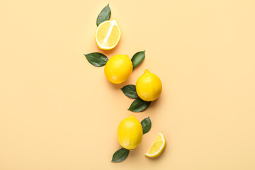 Composition with ripe lemons and leaves on color background