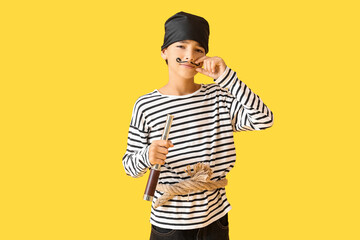 Little boy dressed as pirate with spyglass on yellow background - Powered by Adobe