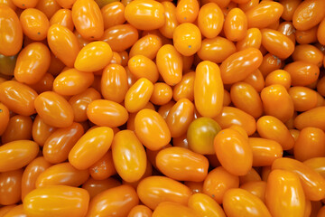 Stack of yellow plum tomatoes a market stall