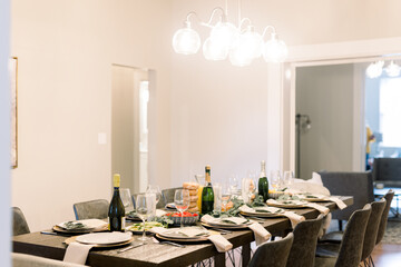 A living space is decorated for brunch with champagne, donuts, plates and napkins