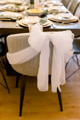 A chair is tied with a white bow at a bruncheon 