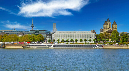 Cologne (Konrad-Adenauer-Ufer), Germany - July 9. 2022: Riverside skyline with St. Kunibert church,...