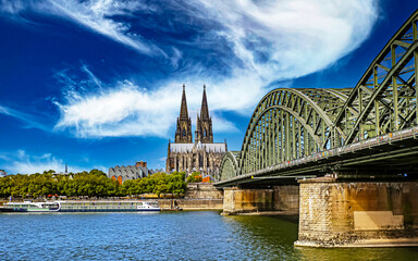 Beautiful river rhine river skyline, medieval gothic dome, Hohenzollern bridge, dramit blue summer sky - Cologne, Germany - obrazy, fototapety, plakaty