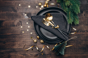 New Year 2023 Christmas table setting black plates and gold decor