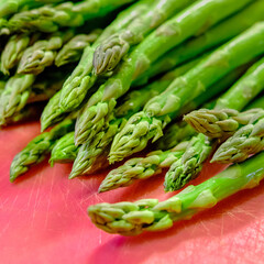 Asparagus on a red cutting mat