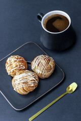 Sweet delicious cake balls in coconut flakes on a golden spoon against the background of coffee Turks. Delicate healthy dessert for coffee. vertical crop. Front view.