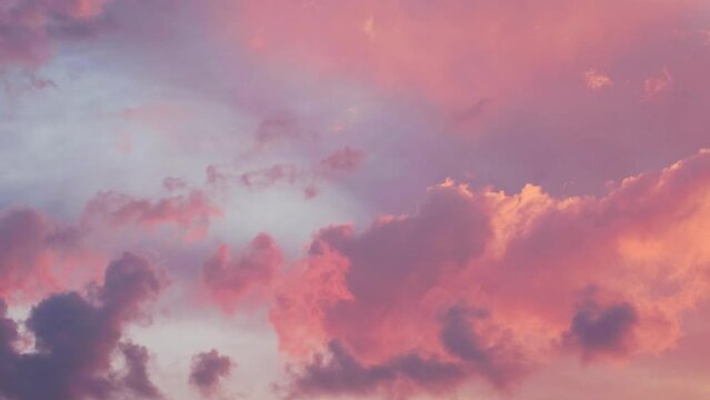 Cloudy sky with moving evening gold orange pink clouds. Beautiful Sunset or Sunrise. Natural background dramatic sky. Amazing light of nature cloudscape sky. Relax Timelapse Time-Lapse Time lapse 