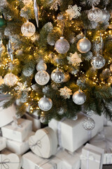 White gift boxes under Christmas tree