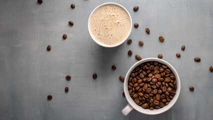 Coffee beans and coffee bewerage on a gray background. Top view, copy space.