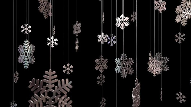 Shiny textured snowflakes are spinning on threads