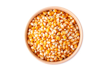 Raw popcorn kernels, seeds or grains in the ceramic bowl isolated on white background