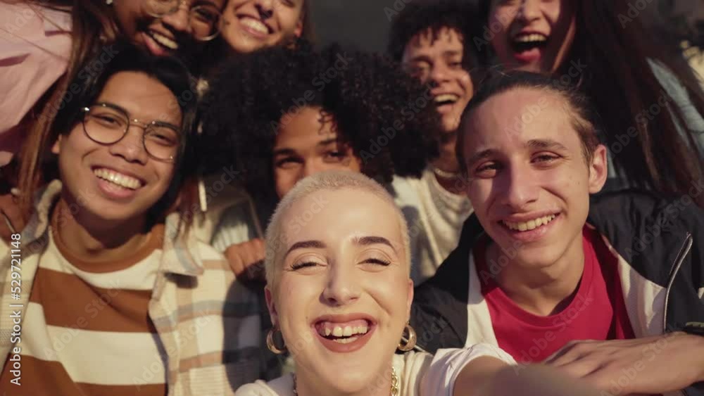 Wall mural multiethnic group of young friends taking a selfie. and having fun.the focus is on shaved hair woman