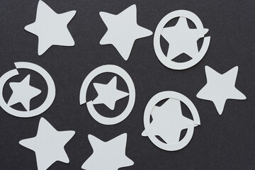 paper stars and circles on dark gray paper