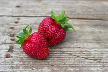 ripe organic strawberries on wooden background