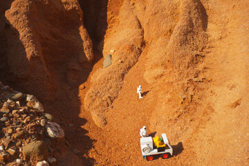 three astronauts exploring mars with a vehicle, concept
