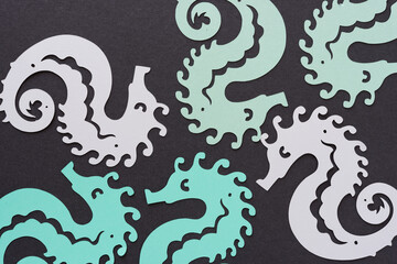 background with paper seahorses © eugen