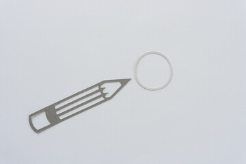 writing instrument (pencil) silhouette and paper circle or ring on blank paper