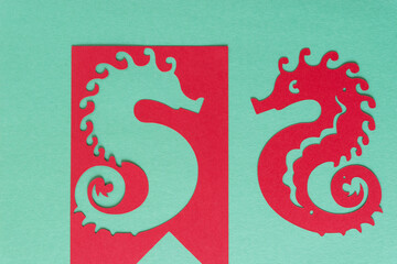 paper seahorse and stencil on green © eugen