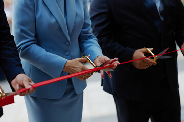 cutting a red ribbon by an adult aristocratic woman