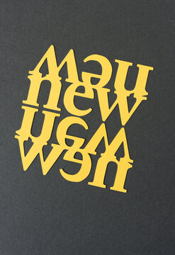 the word "new" (double or mirrored) in yellow card stock on blank paper