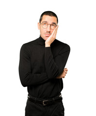 Relaxed young man making a gesture of sleep