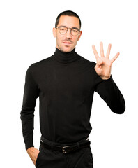 Young man making a number four gesture