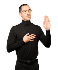 Fototapeta premium Serious young man with a gesture of oath