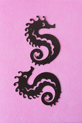 grungy, dark brown paper card seahorses on pink felt