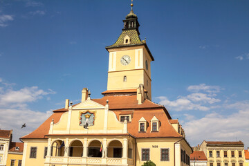 Fototapeta na wymiar Brasov, Romania, the central square of the city of Brasov, the old ranotsny square, tower with hours in the center - Aug 2022