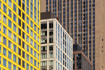 Fototapeta premium Rows of windows in residential skyscrapers. Dense rows of modern high-rise residential buildings. The problems of urban overpopulation. Residential skyscrapers