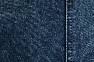 Naklejka premium Texture of dark blue jeans as background, closeup