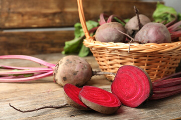 Cut raw ripe beet on wooden table