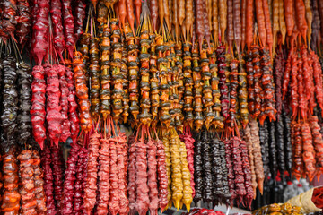 Bunches of different delicious churchkhelas at market