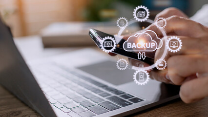 Mobile phone synchronizing data with a computer for backup over a wireless connection with a hand holding smartphone